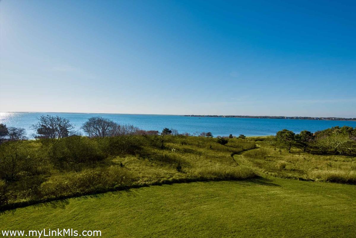 25 Lelands Path Edgartown, MA 02539 - Photo 55 of 56 a view of a lake with houses in the background