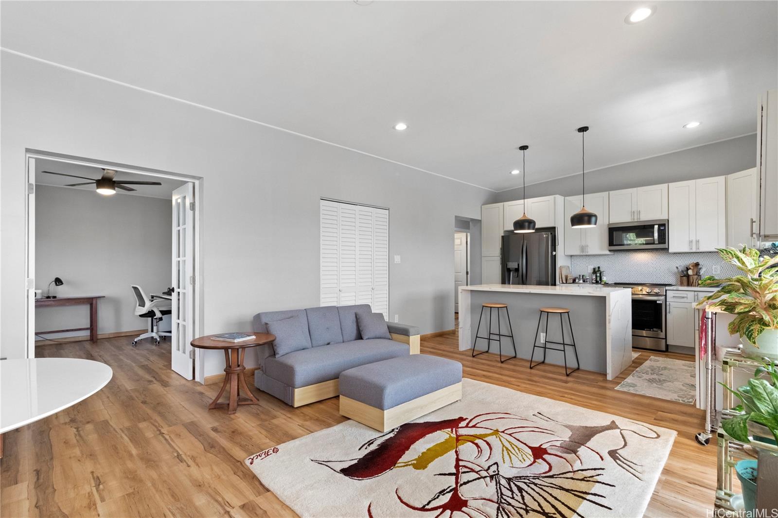 a living room with furniture and a wooden floor