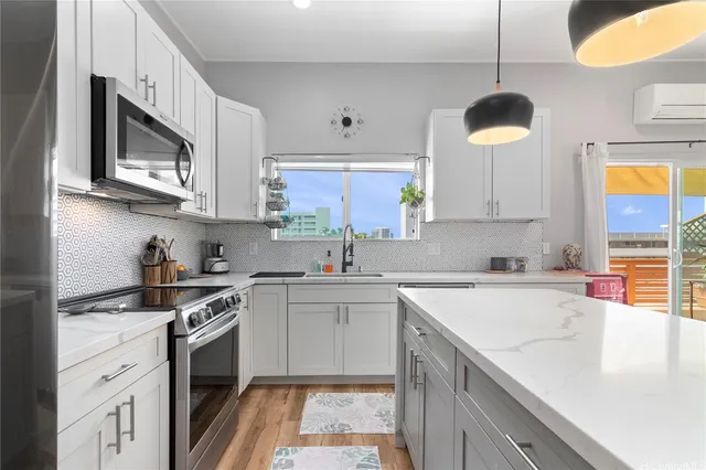 a kitchen with stainless steel appliances granite countertop a sink and a stove top oven