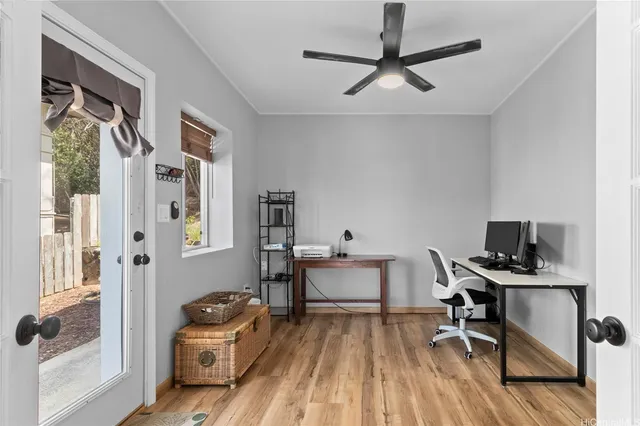 a view of a workspace with furniture and a window