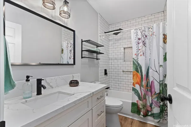 a bathroom with a sink a toilet and shower curtain