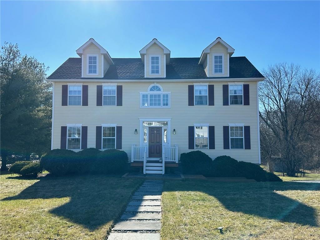 a front view of a house with garden