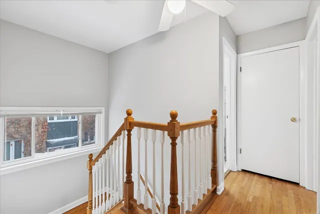 a view of a hallway with wooden floor and entryway