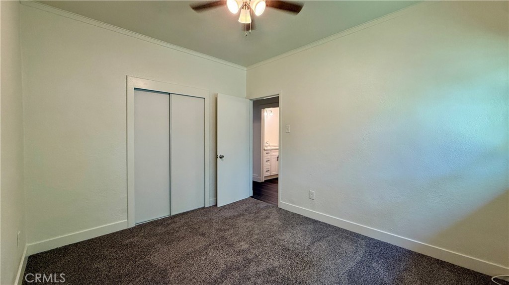 4542 Bandini Avenue Riverside, CA 92506 - Photo 20 of 22 an empty room with a ceiling fan and a window