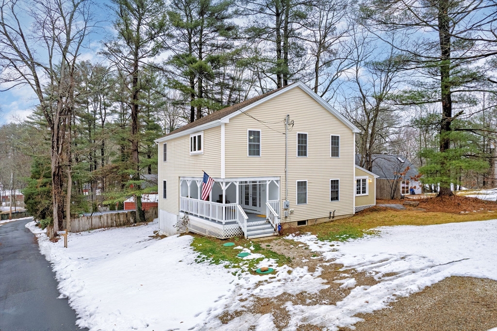 a view of a house with a yard covered in snow