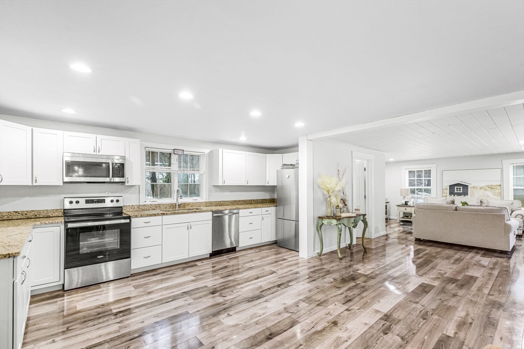 63 South Cottage Road Holland, MA 01521 - Photo 2 of 35 a large kitchen with stainless steel appliances lots of counter space and wooden floor