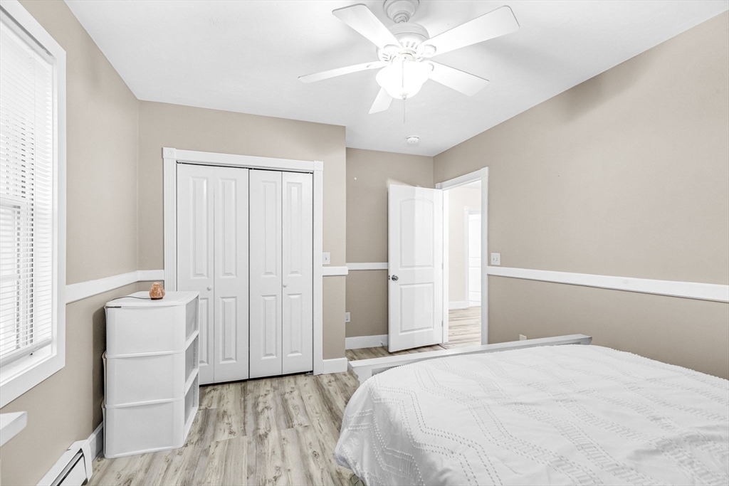 63 South Cottage Road Holland, MA 01521 - Photo 21 of 35 a bedroom with a bed and a chandelier