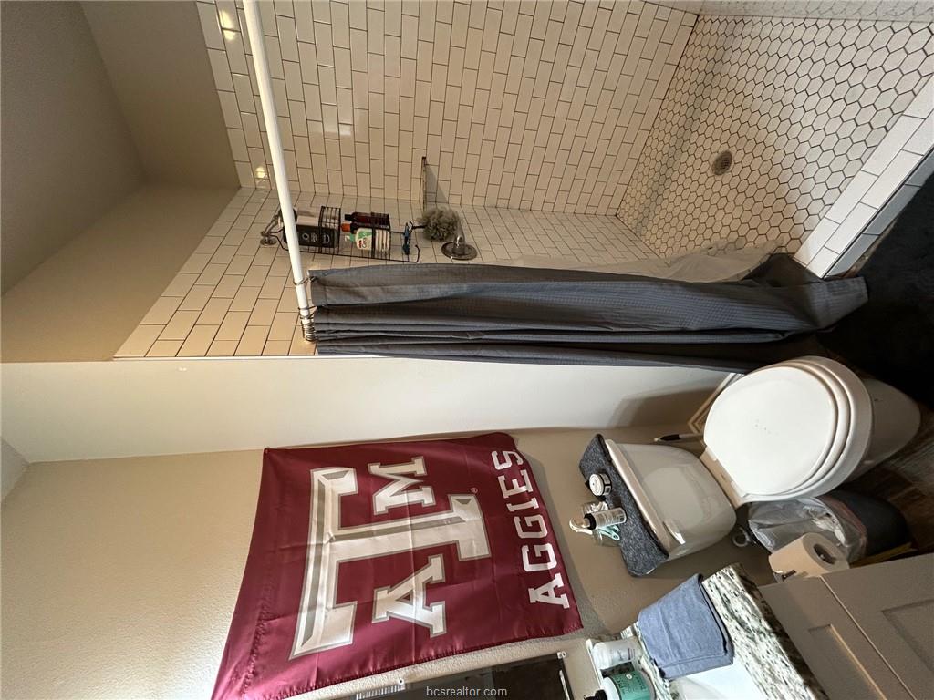 632 Clay Street Bryan, TX 77801 - Photo 9 of 15 a bathroom with a toilet and a shower