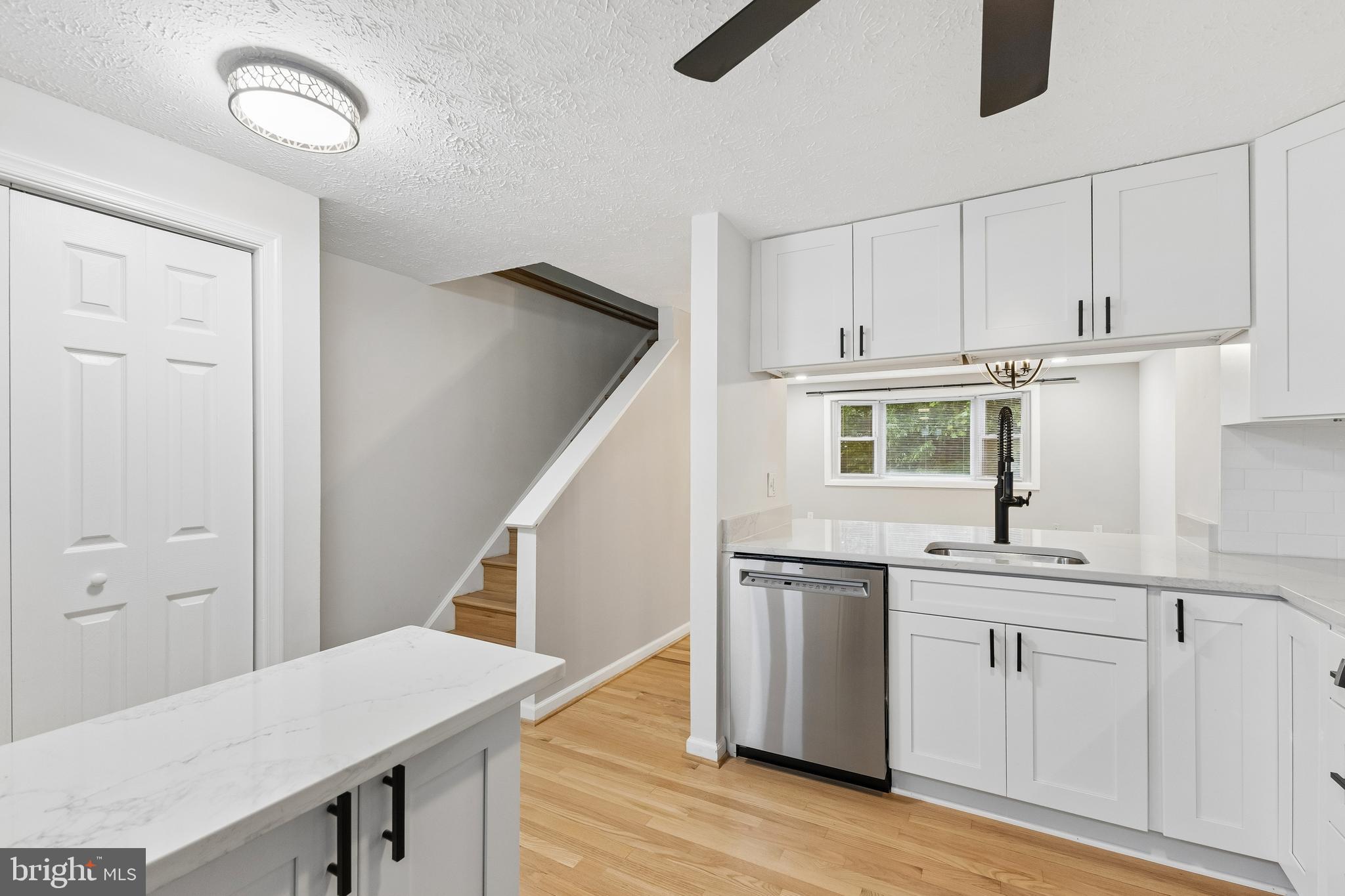 8317 Brookvale Court Springfield, VA 22153 - Photo 16 of 33 a kitchen with cabinets and wooden floor