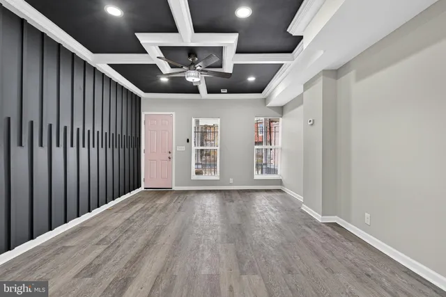 a view of an empty room with wooden floor