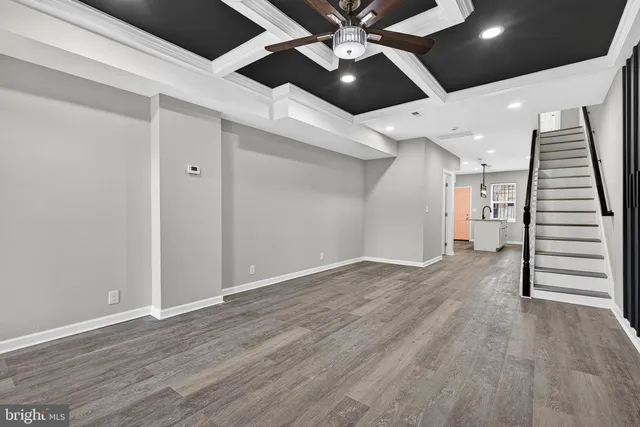 wooden floor in an empty room with a ceiling fan