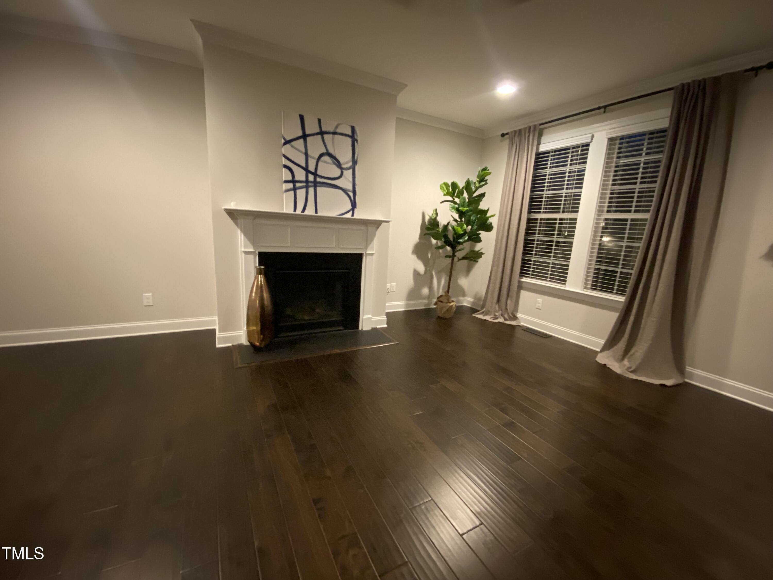 1304 Revolution Circle Raleigh, NC 27603 - Photo 6 of 17 a view of an empty room with wooden floor and a window