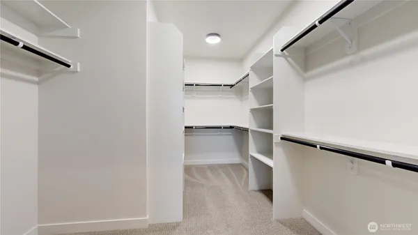 a view of walk in closet with empty racks