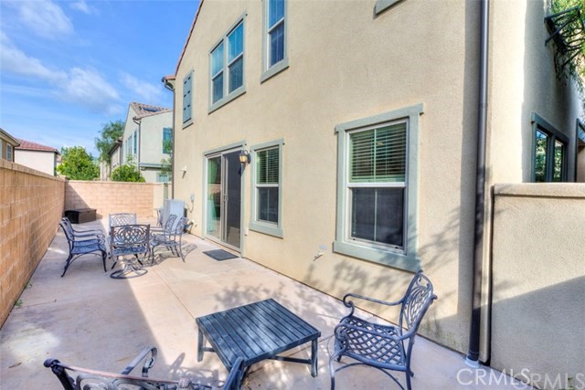184 Pathway Irvine, CA 92618 - Photo 5 of 7 a view of a patio with a table and chairs and floor to ceiling window and potted plants