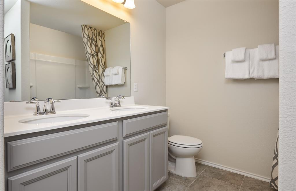 1087 Clear Dusk Lane Forney, TX 75126 - Photo 12 of 12 a bathroom with a granite countertop sink a toilet and a mirror