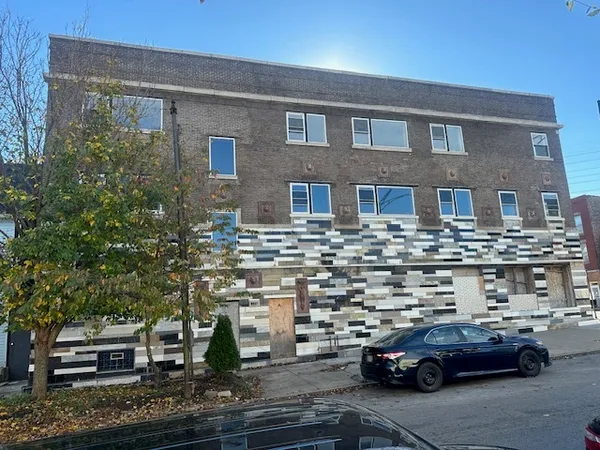 a front view of a building with parking