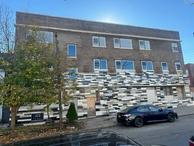 a front view of a building with parking