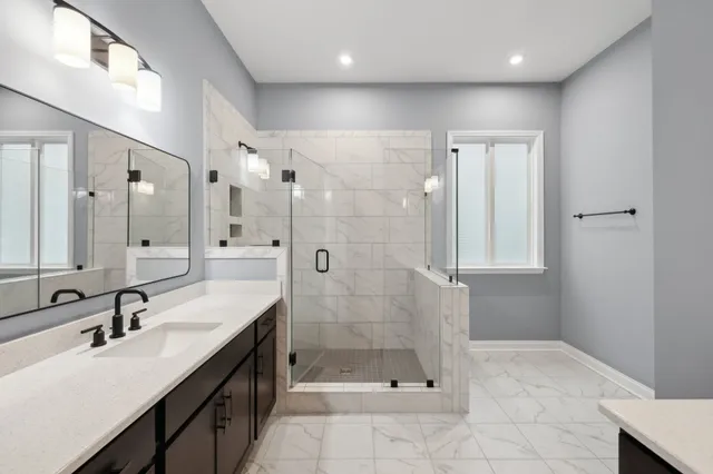 a spacious bathroom with a shower sink and mirror