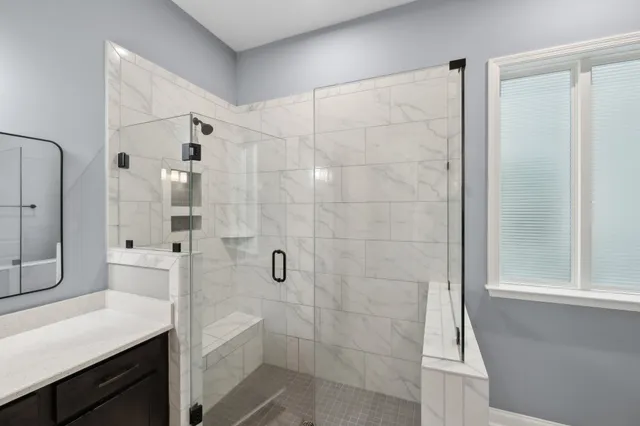 a bathroom with a shower and a sink