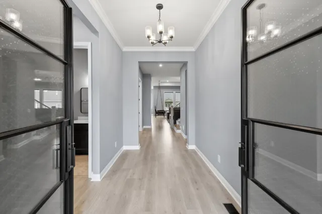 a view of a hallway view with wooden floor and staircase