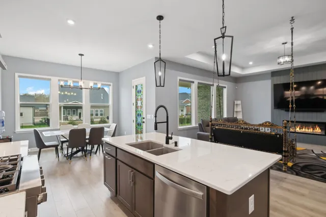 a large kitchen with a table and chairs