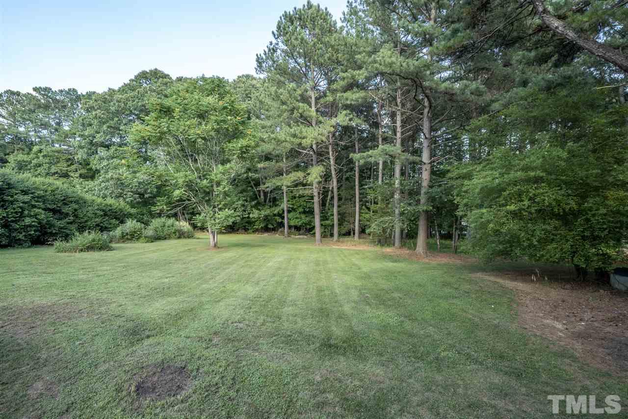 11508 John Allen Road Raleigh, NC 27614 - Photo 21 of 25 a view of a grassy field with trees in the background
