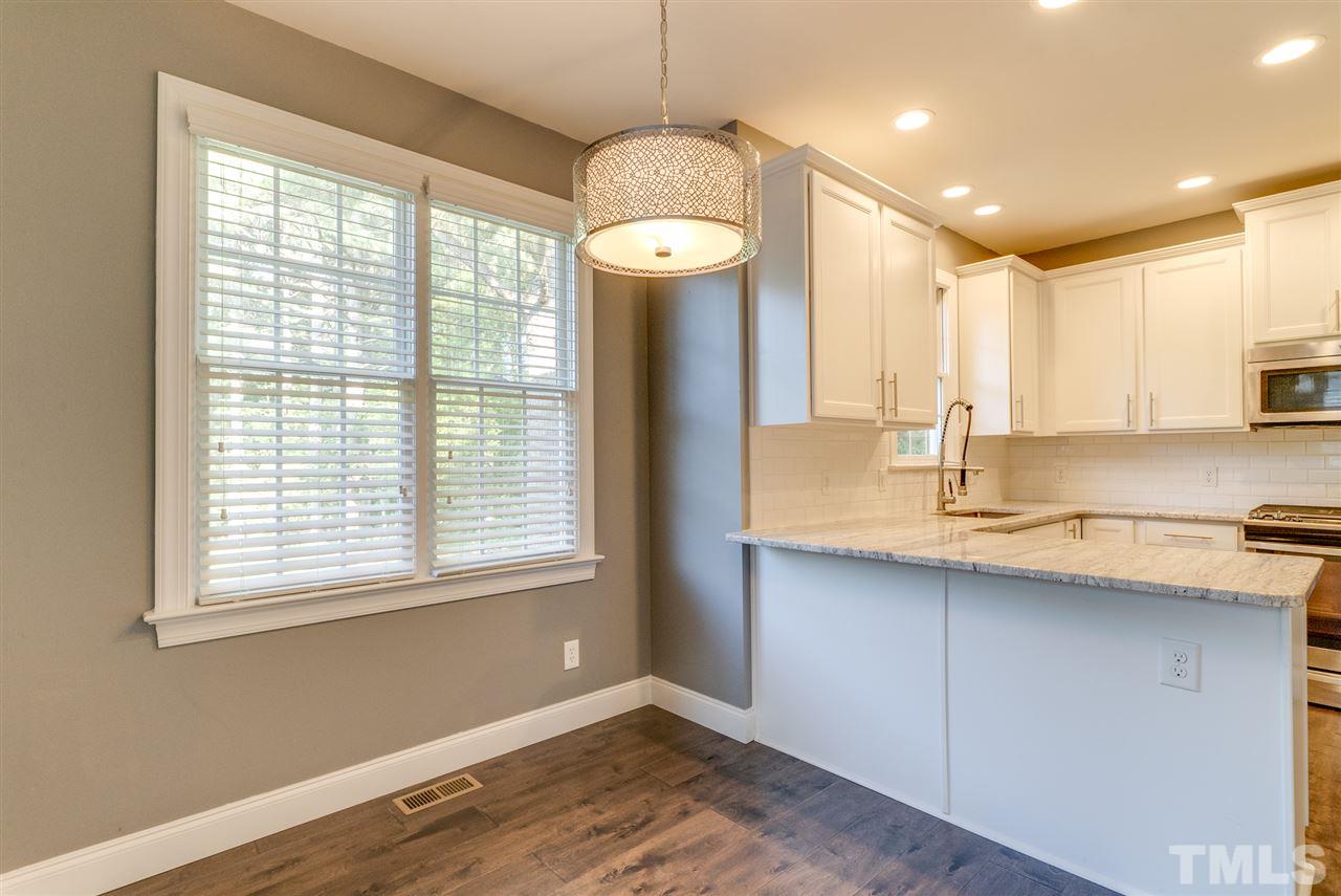 11508 John Allen Road Raleigh, NC 27614 - Photo 24 of 25 a bathroom with a granite countertop sink a large mirror and a window