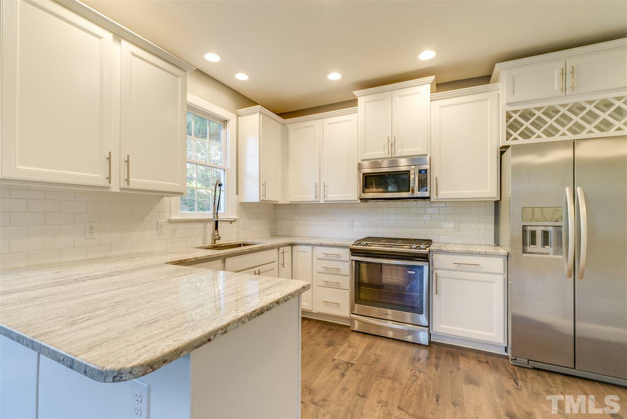 11508 John Allen Road Raleigh, NC 27614 - Photo 7 of 25 a kitchen with stainless steel appliances granite countertop a refrigerator a sink and a stove