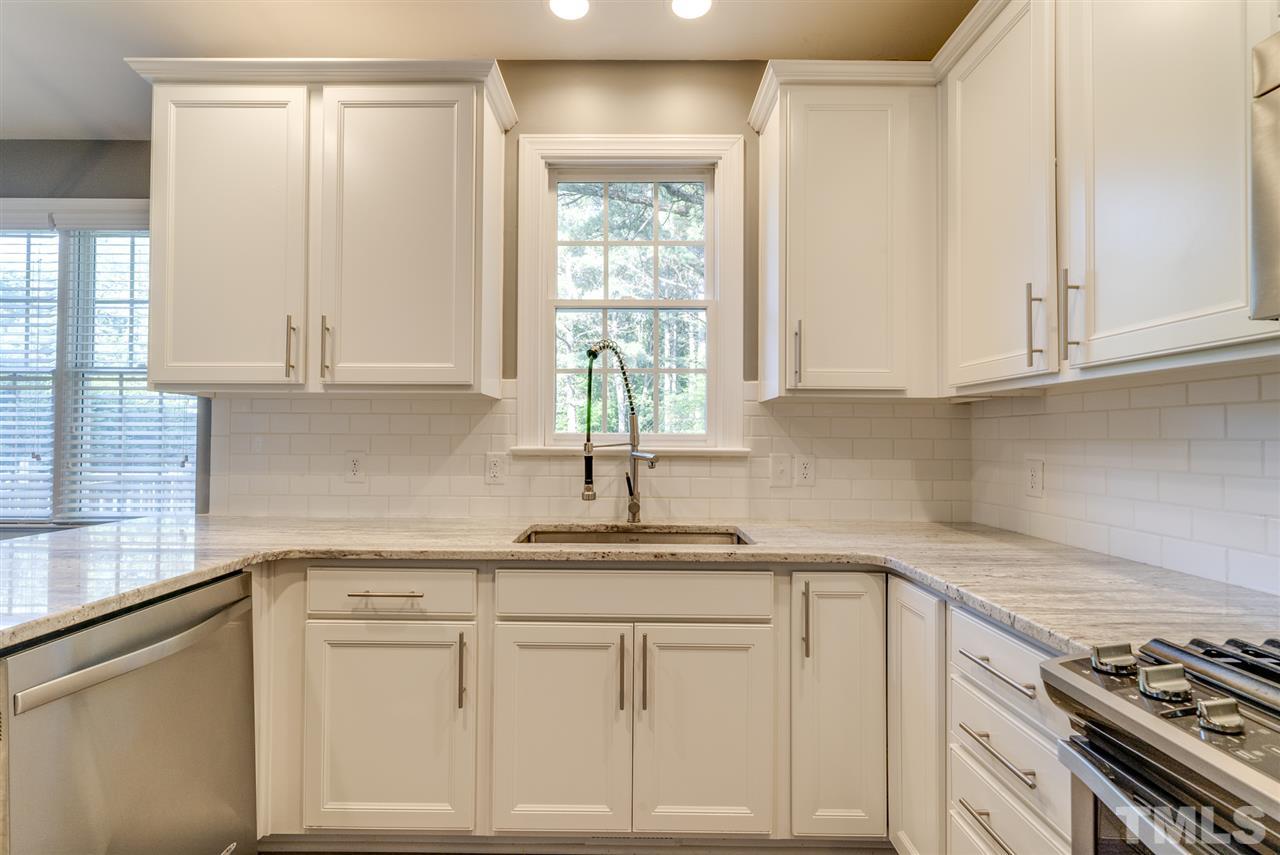 11508 John Allen Road Raleigh, NC 27614 - Photo 8 of 25 a kitchen with granite countertop white cabinets and white appliances
