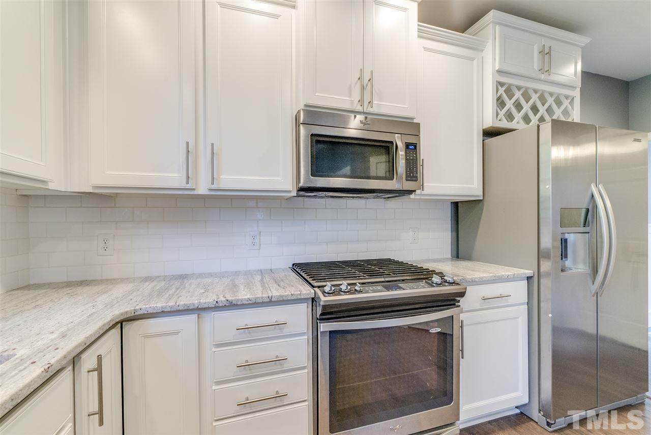 11508 John Allen Road Raleigh, NC 27614 - Photo 10 of 25 a kitchen with stainless steel appliances granite countertop white cabinets and a stove top oven