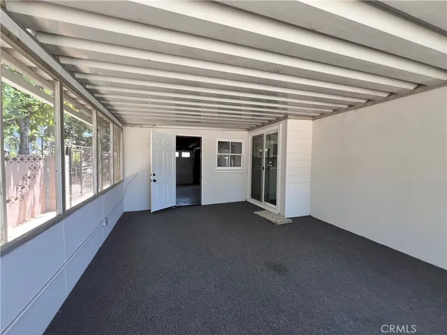 a view of empty room with floor to ceiling windows