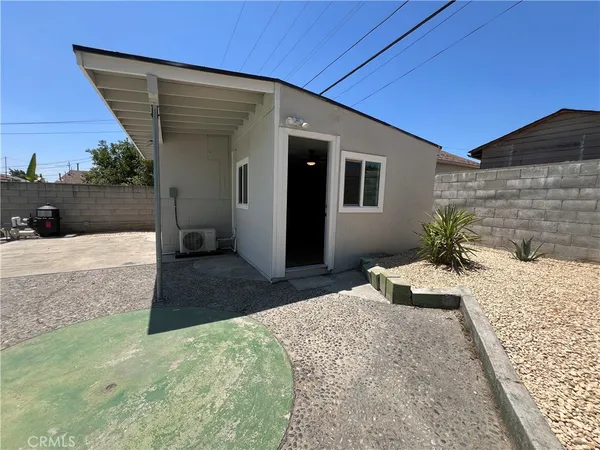 a bedroom with a bed and a potted plant