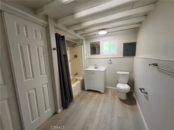 a bathroom with a toilet sink a mirror and a shower