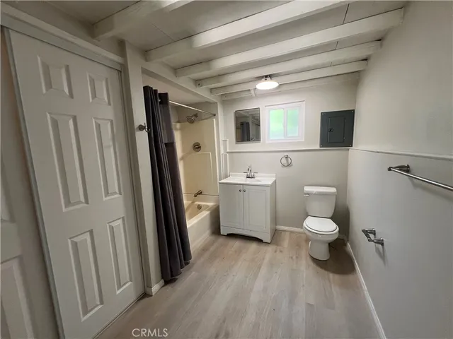a bathroom with a toilet sink a mirror and a shower