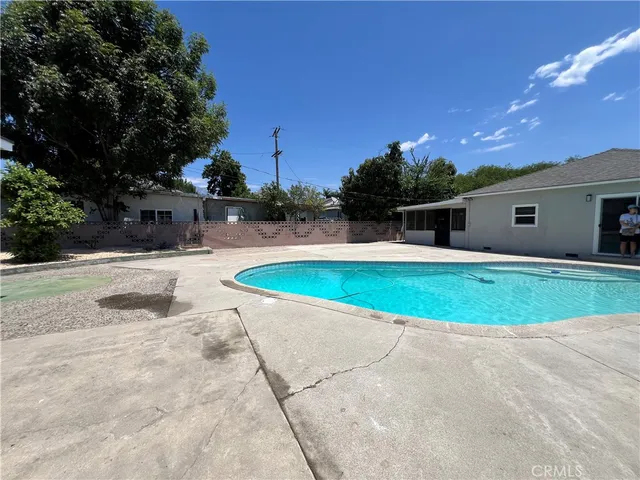 a swimming pool with outdoor seating and yard