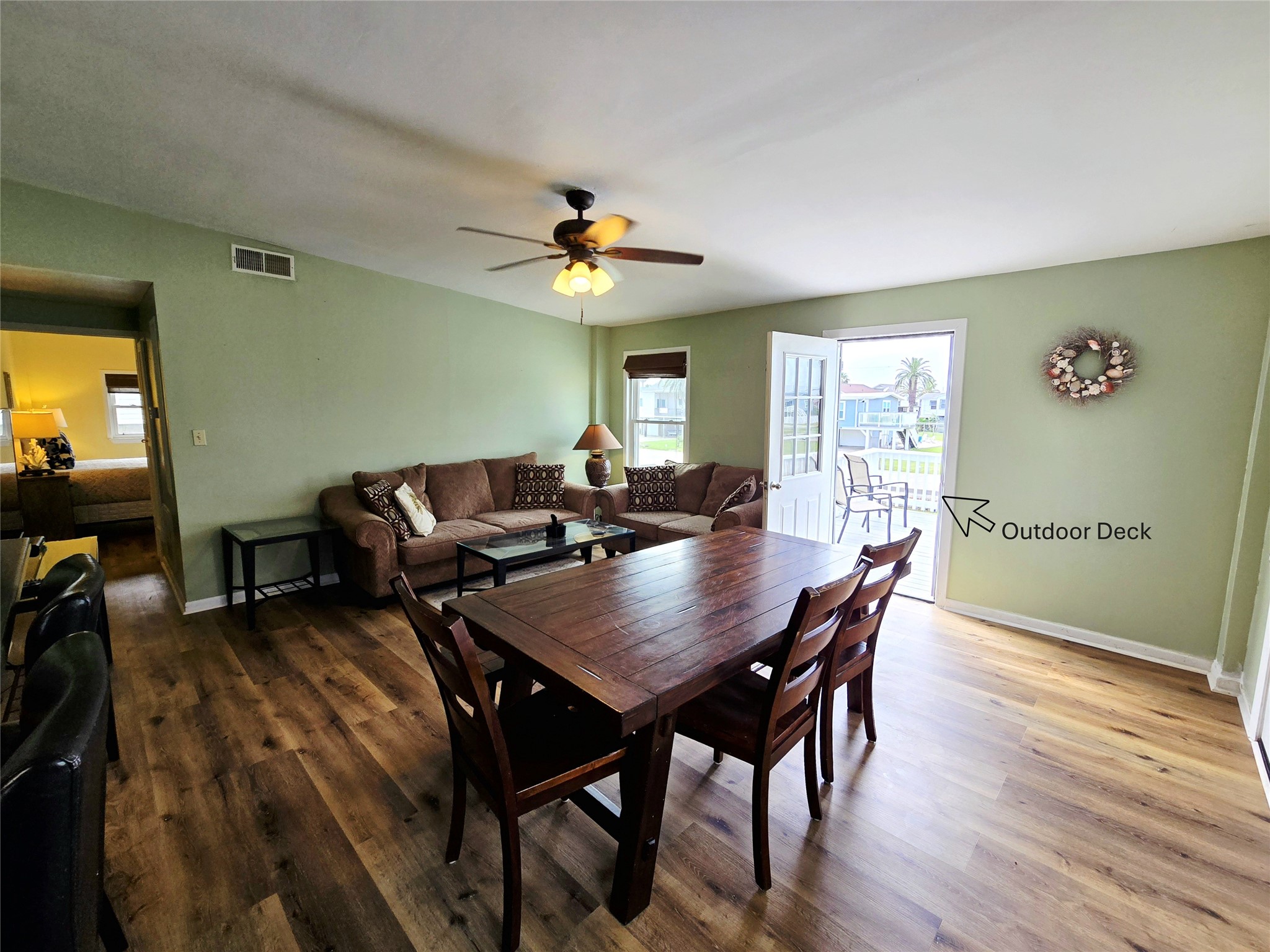 16611 Jolly Roger Road Jamaica Beach, TX 77554 - Photo 11 of 49 a view of a dining room with furniture and wooden floor