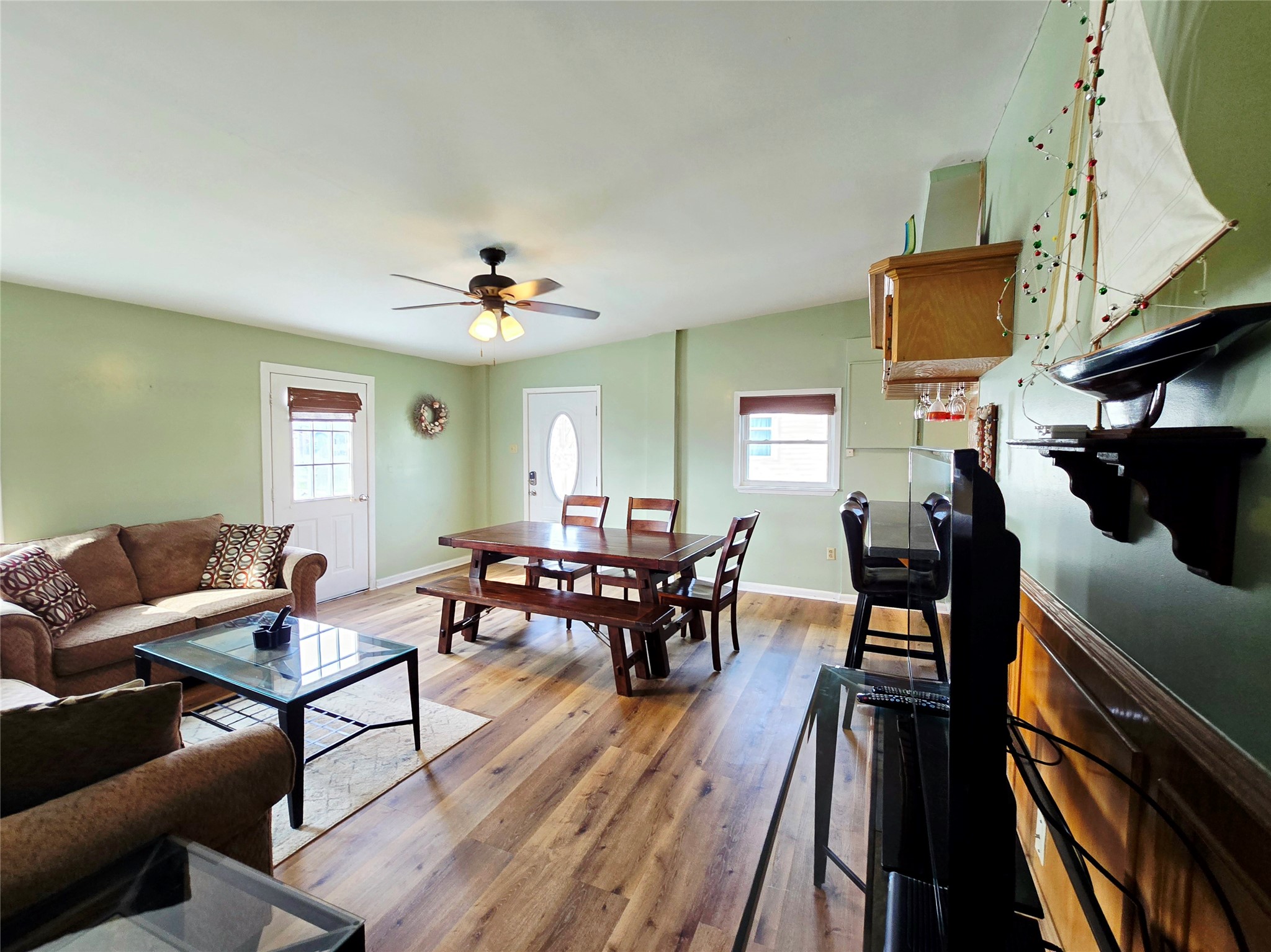16611 Jolly Roger Road Jamaica Beach, TX 77554 - Photo 15 of 49 a living room with furniture a wooden floor and a chandelier