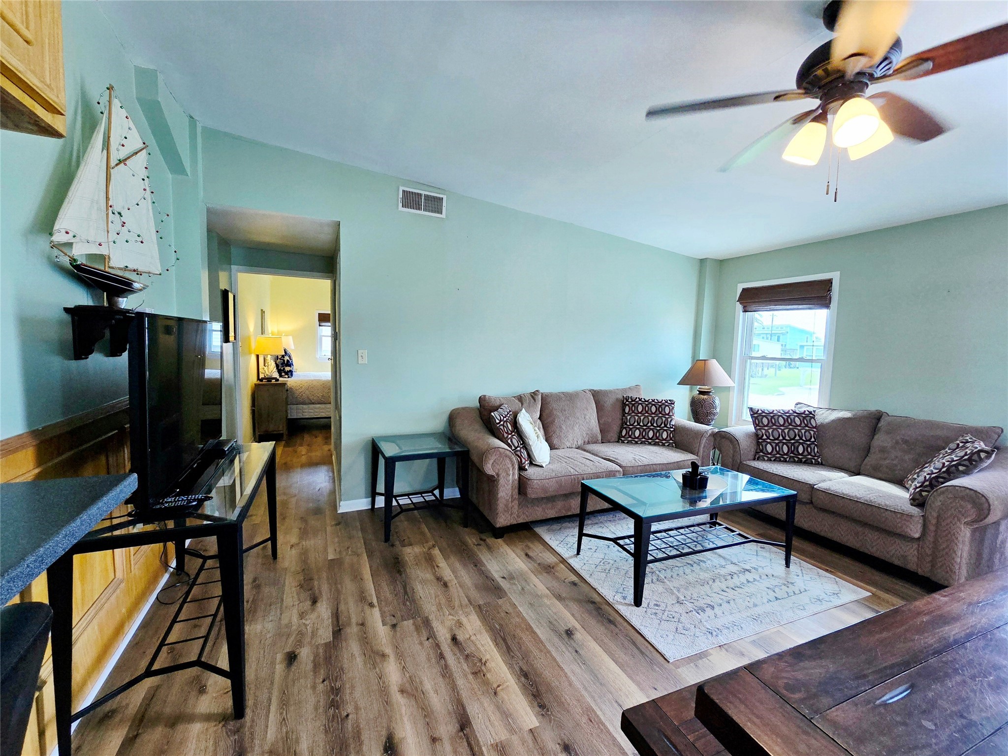 16611 Jolly Roger Road Jamaica Beach, TX 77554 - Photo 17 of 49 a living room with furniture and a flat screen tv