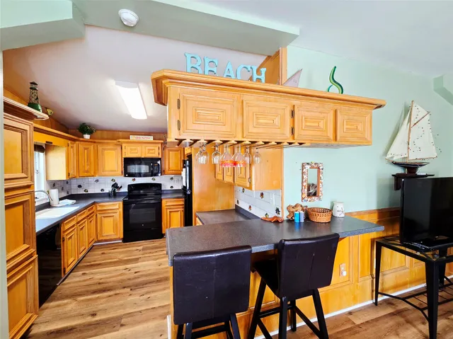 a kitchen with a sink stove top oven and cabinets
