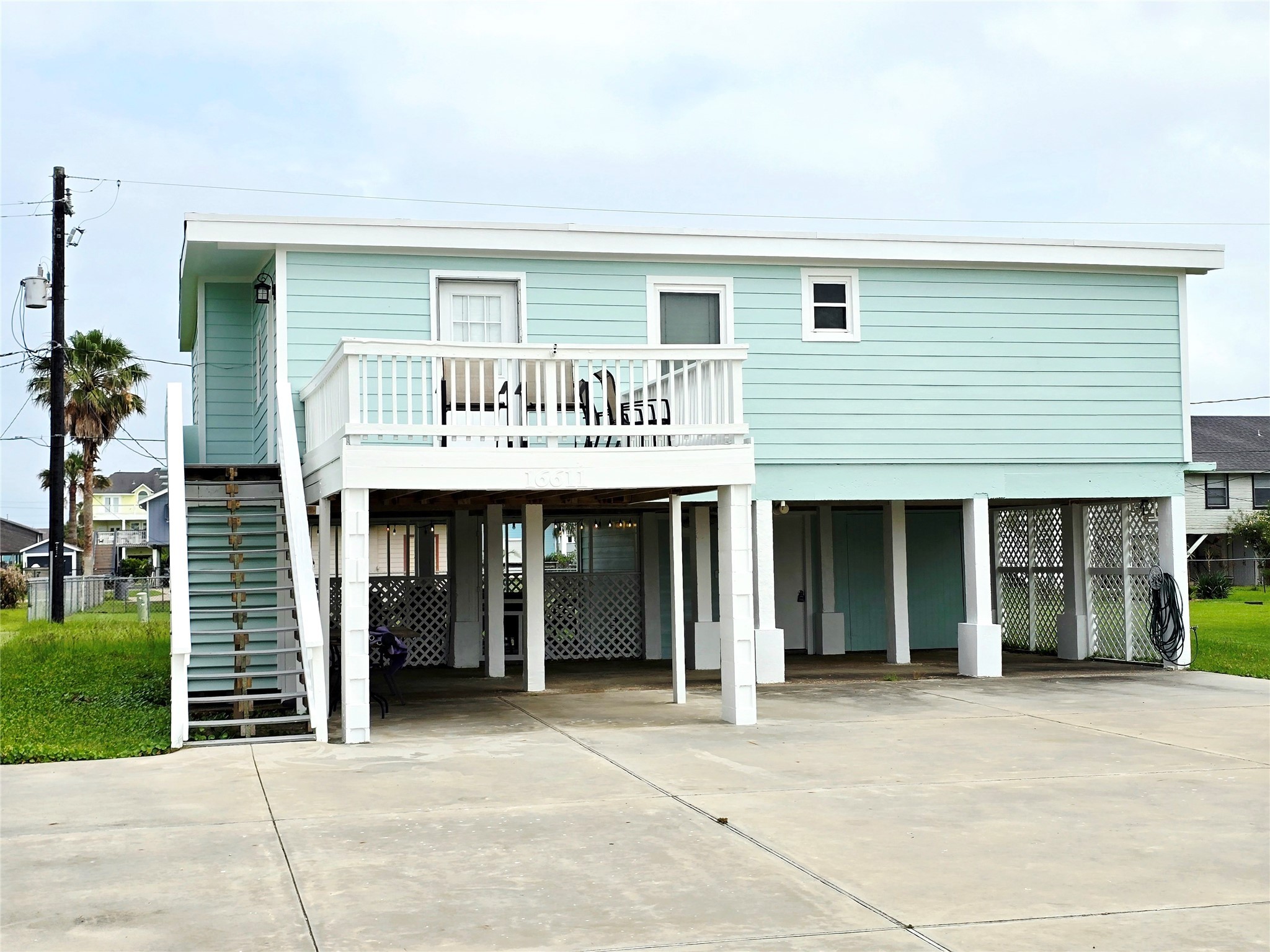 16611 Jolly Roger Road Jamaica Beach, TX 77554 - Photo 2 of 49 a view of a house with large windows and plants