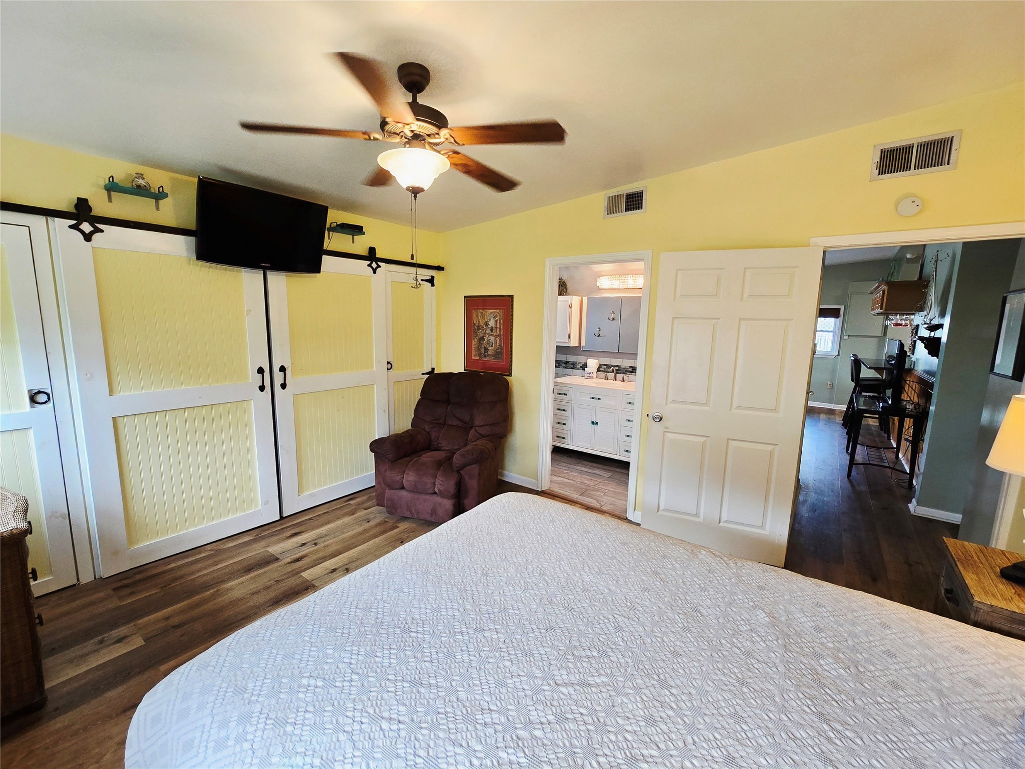 16611 Jolly Roger Road Jamaica Beach, TX 77554 - Photo 22 of 49 a spacious bedroom with a bed and a walk in closet