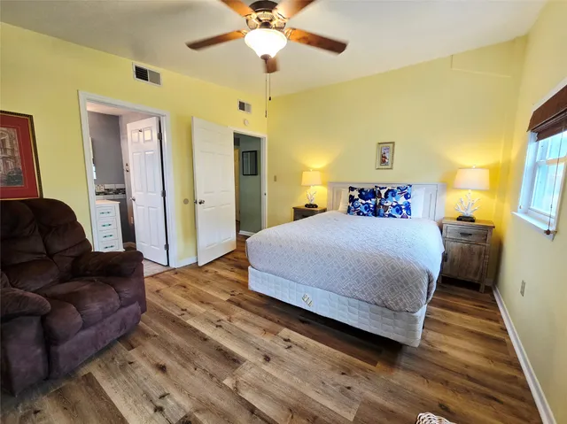 a bedroom with a bed dresser and a window