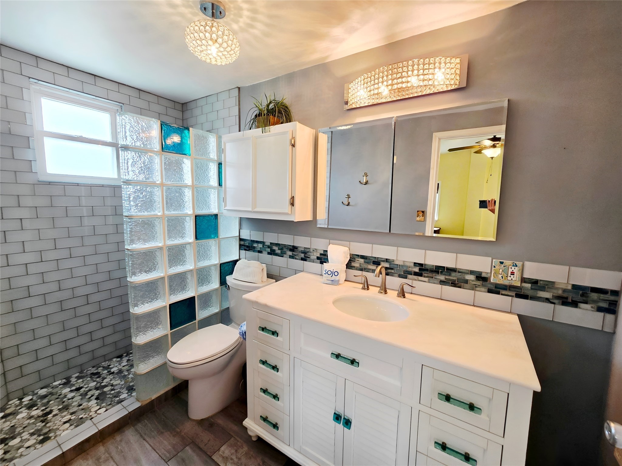 16611 Jolly Roger Road Jamaica Beach, TX 77554 - Photo 25 of 49 a bathroom with a sink mirror toilet and shower