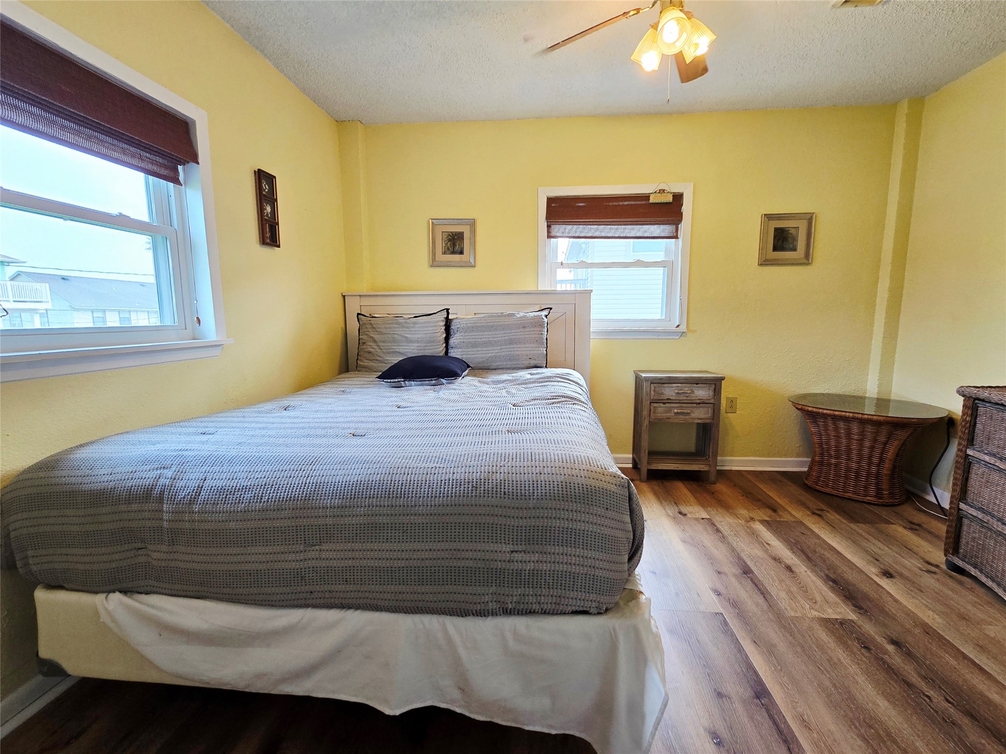 16611 Jolly Roger Road Jamaica Beach, TX 77554 - Photo 31 of 49 a bedroom with a bed and wooden floor