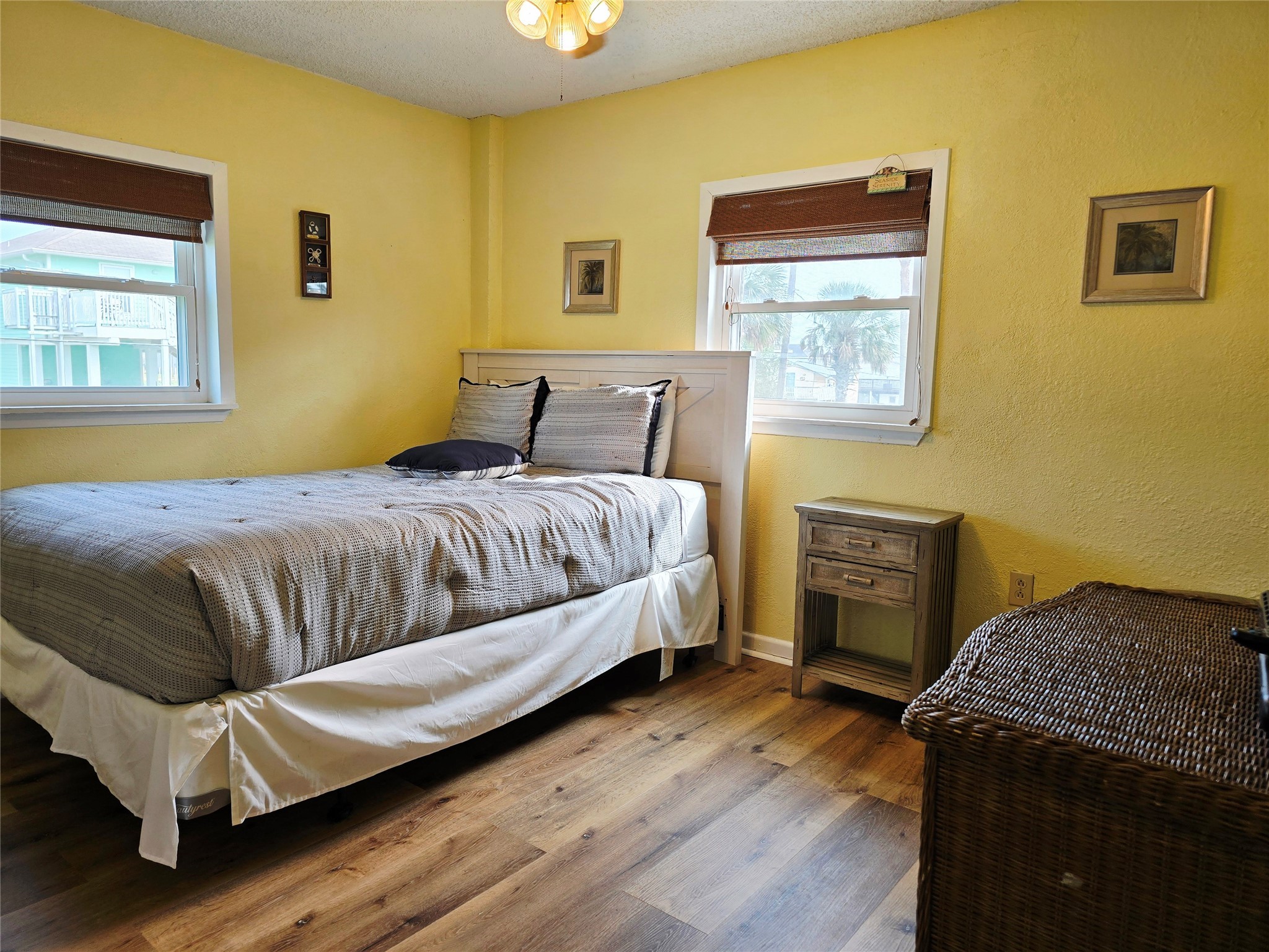 16611 Jolly Roger Road Jamaica Beach, TX 77554 - Photo 32 of 49 a bedroom with a bed and wooden floor