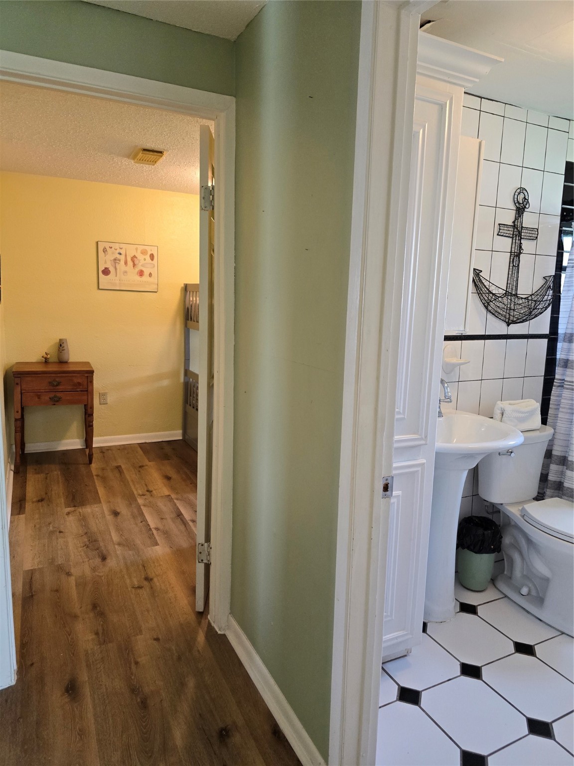 16611 Jolly Roger Road Jamaica Beach, TX 77554 - Photo 33 of 49 a bathroom with a sink and a toilet