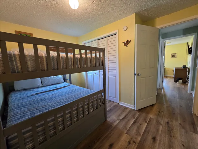 a view of a hallway with wooden floor and stairs