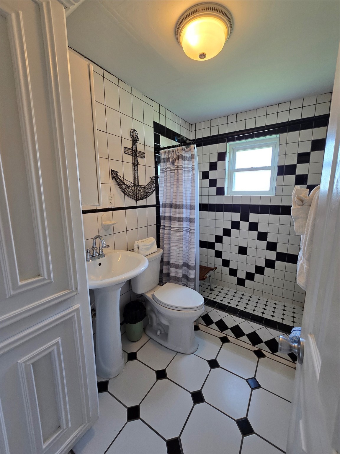 16611 Jolly Roger Road Jamaica Beach, TX 77554 - Photo 38 of 49 a bathroom with a sink toilet and shower
