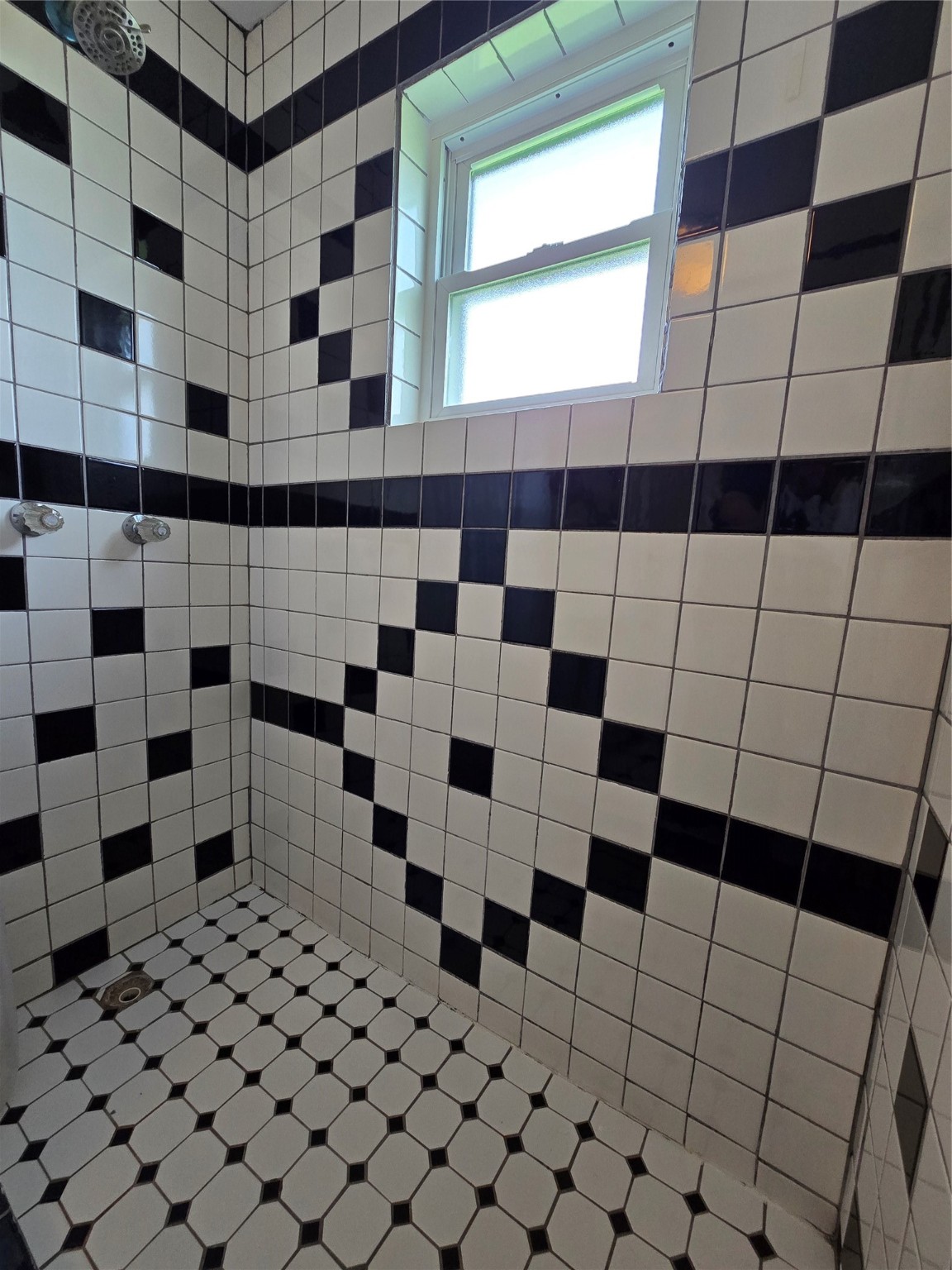 16611 Jolly Roger Road Jamaica Beach, TX 77554 - Photo 39 of 49 a bathroom with a black and white checkered floor