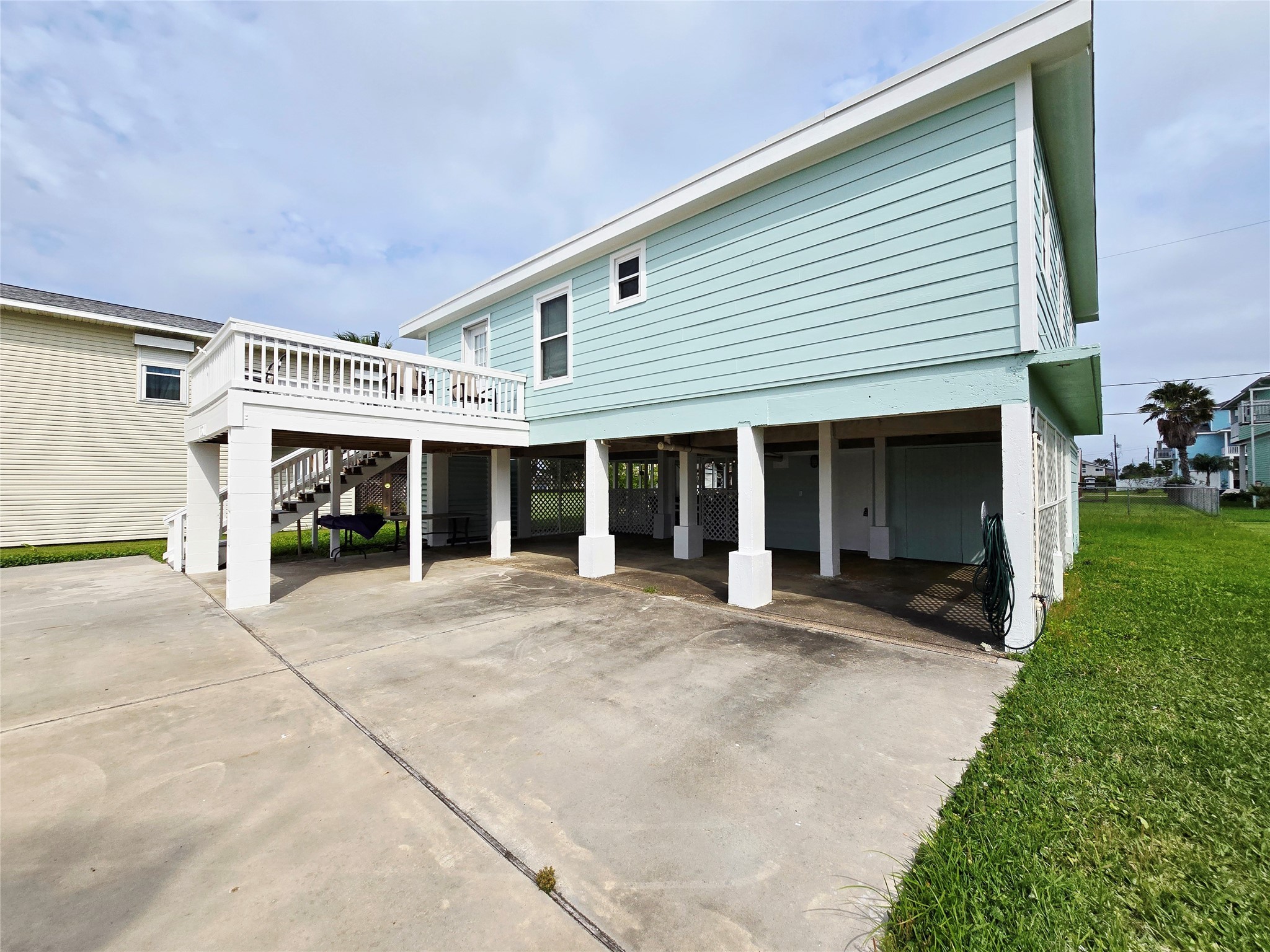 16611 Jolly Roger Road Jamaica Beach, TX 77554 - Photo 41 of 49 a front view of a house with a yard and garage